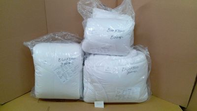three bags of white toilet paper sitting on top of a cardboard box