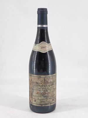 bottle of red wine with a label on it sitting on a white surface