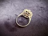 a close up of a gold ring with a crown on it