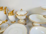 beaucoup d'assiettes et de bols blancs et dorés