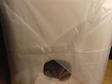 a plastic bag wrapped around a computer monitor on a desk