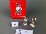 a close up of a small toy figure next to a box of matches