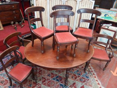 une table avec six chaises et un tapis au sol