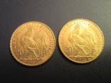 a close up of two gold coins on a black surface