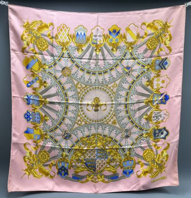a pink scarf with gold and blue designs on it