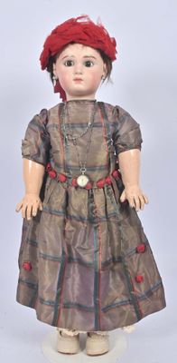 an image of a doll with a red hat and brown dress