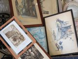 a box full of framed pictures and pictures on the floor