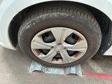 a white car that has a flat tire on it