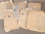a lot of old letters and envelopes sitting on a table