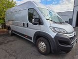 a picture of a silver van parked in front of a building
