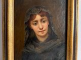 une peinture à l'huile représentant une femme vêtue d'un châle noir, dans un cadre doré