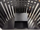 a metal bench that is sitting on the sidewalk