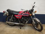 a red and black motorcycle parked in a garage