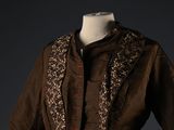 jacket worn by a woman in a brown dress with a floral pattern on the collar