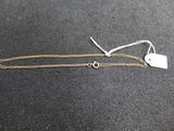 a close up of a gold chain with a tag on it