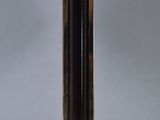 a close up of a lamp on a wooden base with a brown shade