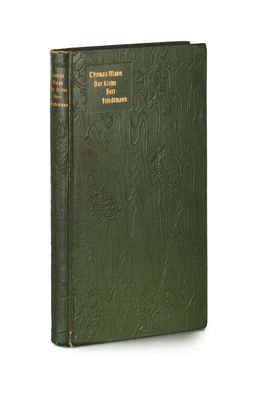 a book with a green cover sitting on top of a white surface