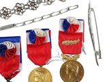 three medals and a pair of scissors on a white background