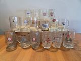 a lot of beer glasses sitting on a wooden table