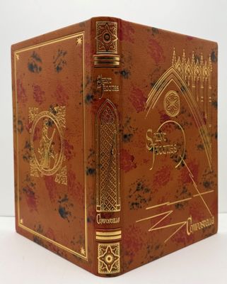 an old book sitting on top of a white table next to a white wall