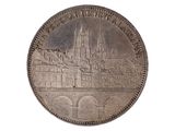 an old silver coin with a picture of a castle on it
