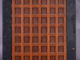 a wooden door that is open on the side of a building