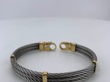 a cable bracelet with two gold clasps on a white background