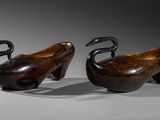 pair of carved wooden ducks with black legs