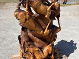 wooden sculpture of horses on a wooden pallet in front of a building