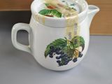 a tea pot with a tea bag in it and a box of tea bags in the background