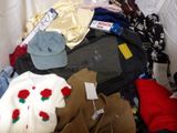 a pile of clothes that is sitting on a bed