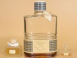 a bottle of perfume with a bow on the top of it
