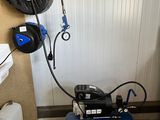 an image of a small air compressor in a garage