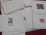 many envelopes on a table with a red table cloth
