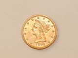 a close up of a gold coin with a woman ' s head on it