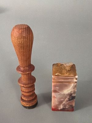 a small wooden object next to a small wooden object