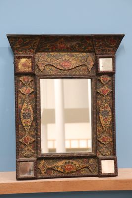 a mirror on a shelf with a blue wall in the background