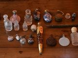 a lot of glass bottles and a pen sitting on a table