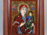 une image d'un tableau représentant une femme tenant un enfant dans ses bras