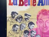poster of a man surrounded by a bunch of people on a wall
