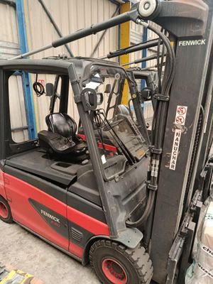 a forklift truck that is parked in a warehouse