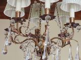 a chandelier that has five lights hanging from it