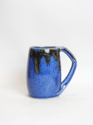 a close up of a blue coffee mug on a white background