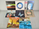 several albums of various music are arranged on a table