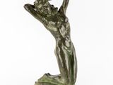 a bronze statue of a woman holding her head in her hands