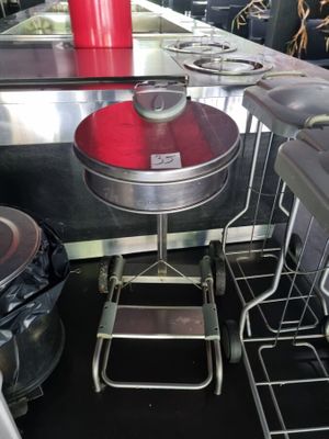 a red cup sitting on top of a table in a kitchen