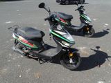 two scooters that are parked in the parking lot