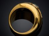 a close up of a gold ring on a black surface