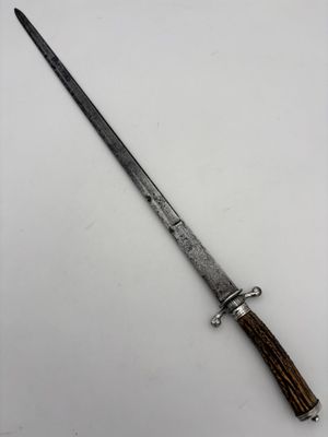 an old knife with a wooden handle sitting on top of a table