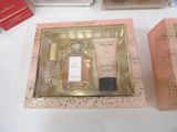 a box with a bottle of perfume next to a box with a bottle of perfume